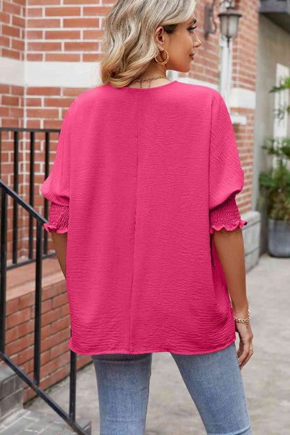 Blouse smockée à manches lanternes et col rond