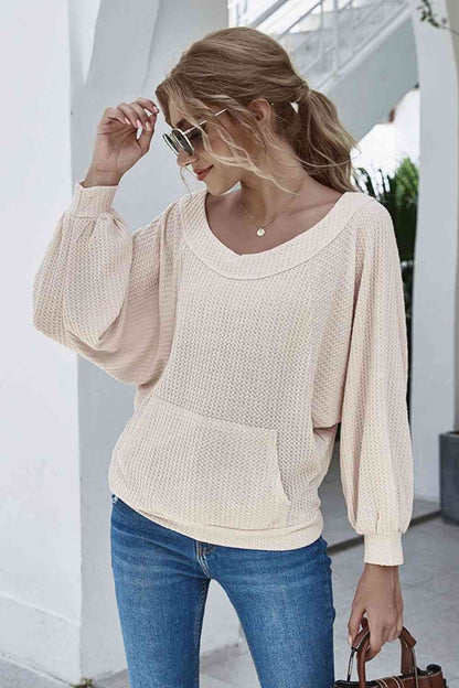 Blusa de punto tipo gofre con cuello barco y manga farol con bolsillo