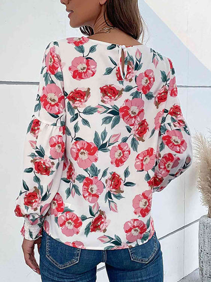 Blouse florale à manches longues bouffantes et col rond