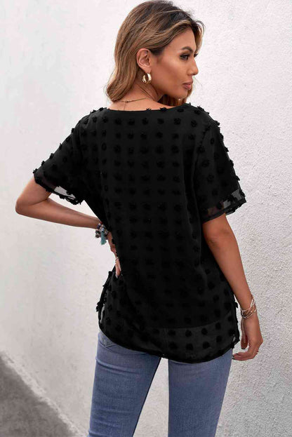 Blusa con cuello redondo y lunares suizos