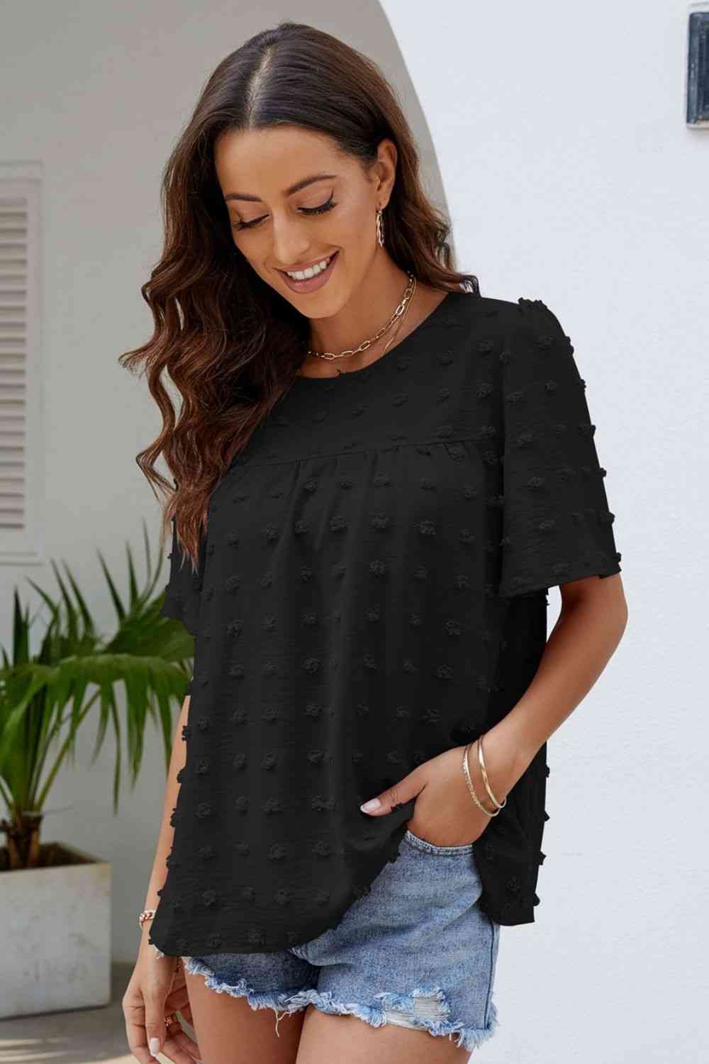 Blusa con cuello redondo y mangas abullonadas con lunares suizos