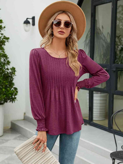 Blouse smockée à col rond et manches lanternes