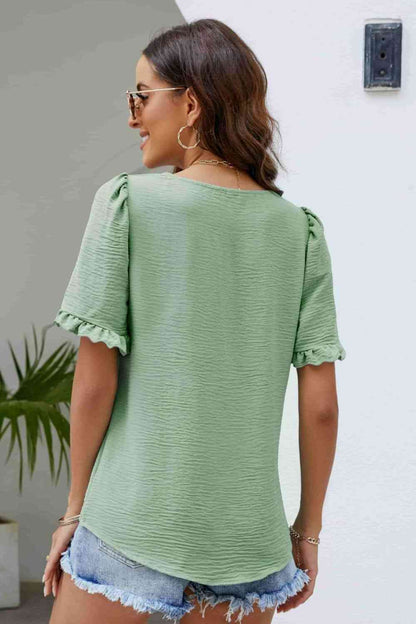 Blusa con cuello cuadrado y manga abullonada con ribete de volantes