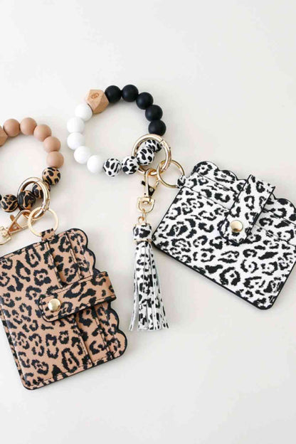 Paquete de 2 llaveros de pulsera con borla y mini monedero de leopardo al azar