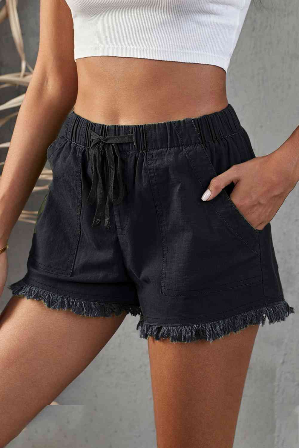 Shorts vaqueros deshilachados con bolsillos