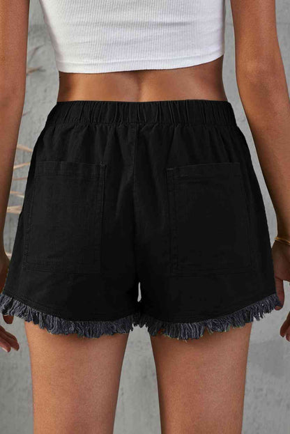 Shorts vaqueros deshilachados con bolsillos