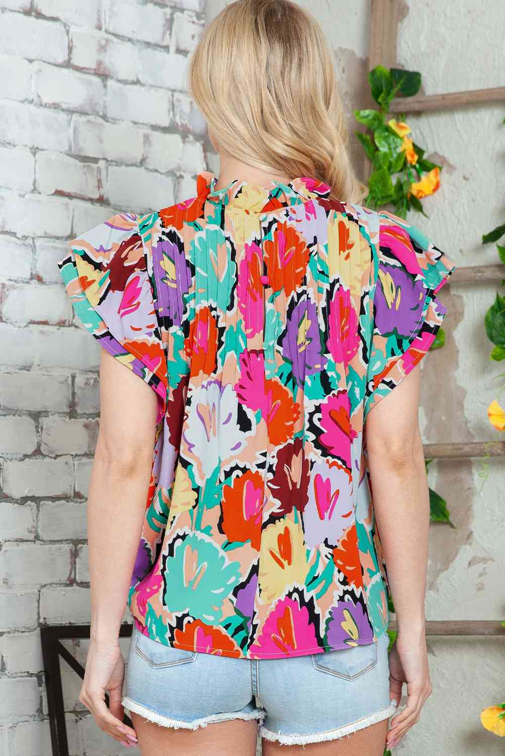 Blouse multicolore à col montant et manches flottantes