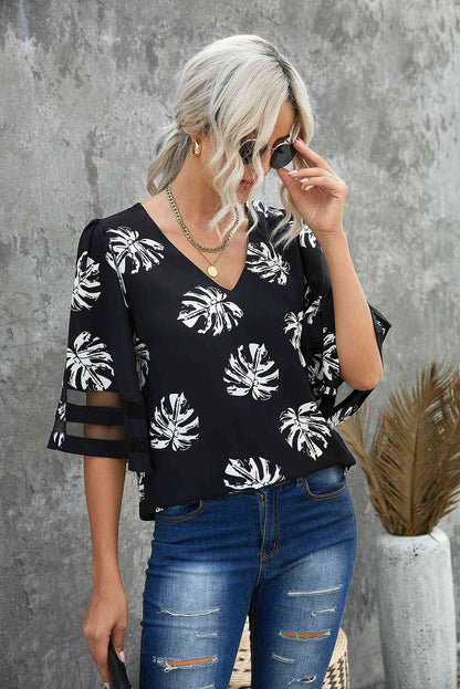 Blusa con manga abullonada y cuello en V con estampado botánico