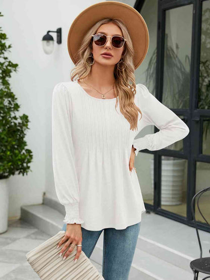 Blouse smockée à col rond et manches lanternes