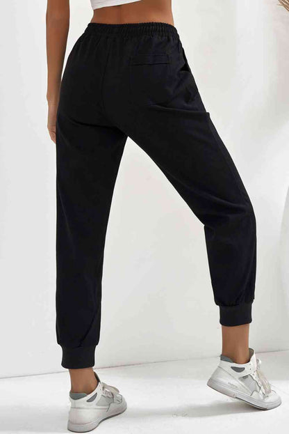 Pantalon de jogging avec poche à taille élastique et cordon de serrage