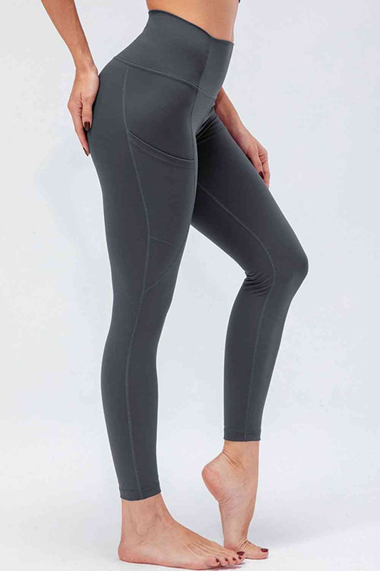 Leggings activos transpirables con cintura ancha y bolsillos