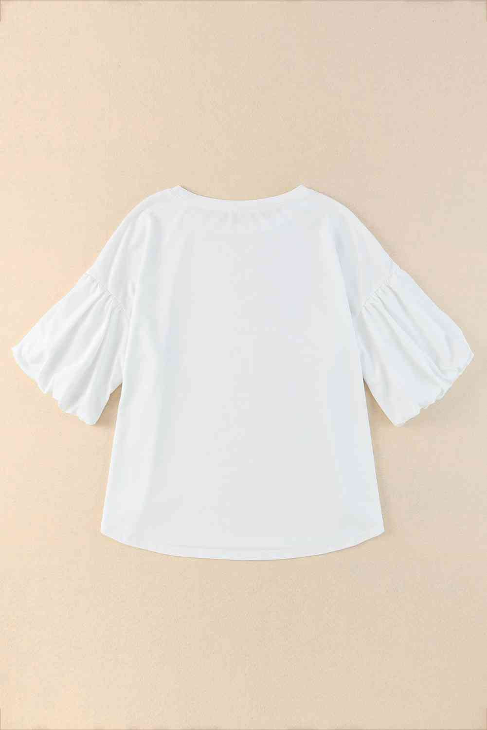 Blouse à manches bouffantes et ourlet arrondi