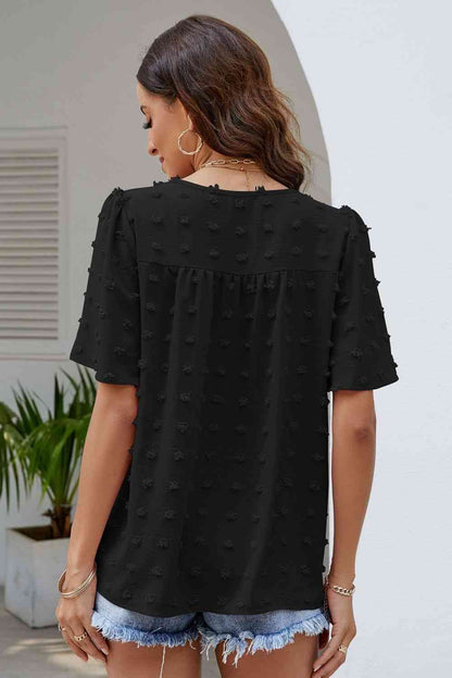 Blusa con cuello redondo y mangas abullonadas con lunares suizos