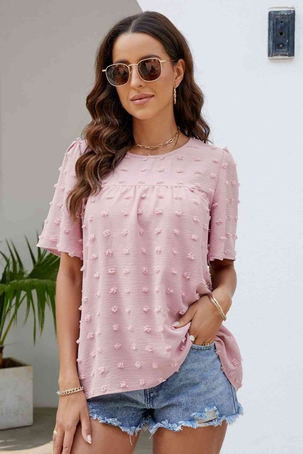 Blusa con cuello redondo y mangas abullonadas con lunares suizos