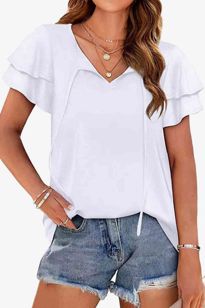 Blusa con mangas acampanadas y capas con cuello anudado