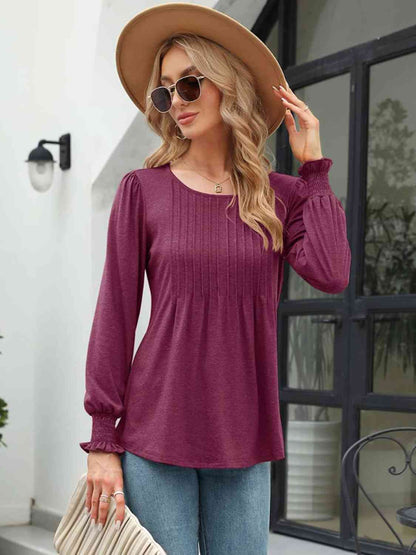 Blouse smockée à col rond et manches lanternes