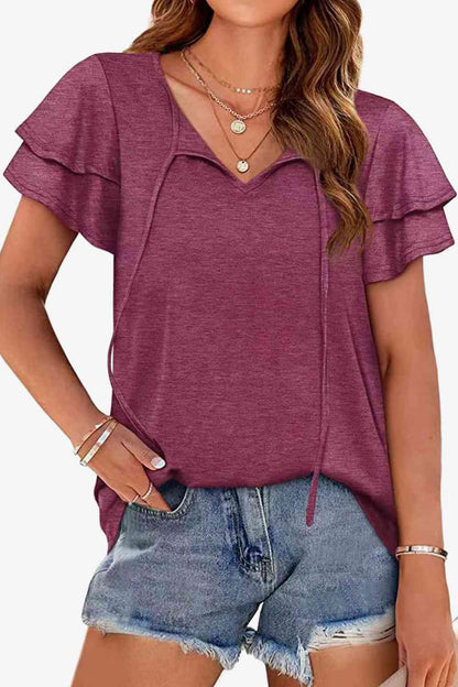 Blusa con mangas acampanadas y capas con cuello anudado