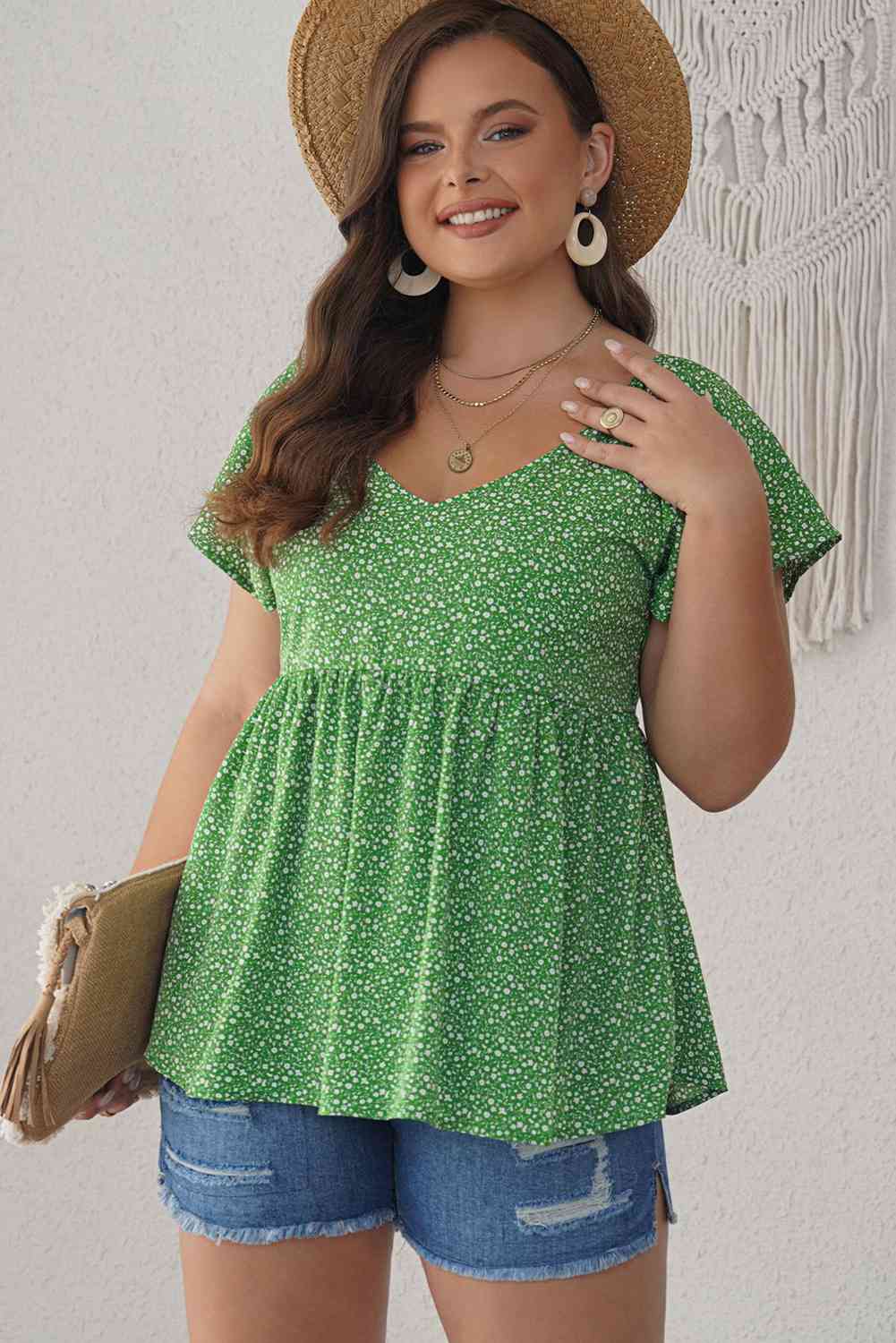 Blusa peplum con mangas acampanadas y estampado floral de florecitas