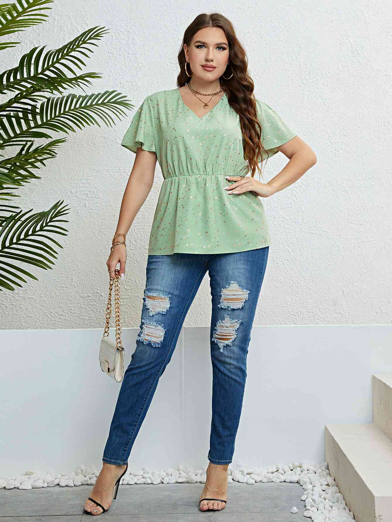 Top peplum con manga abullonada y cuello en V con estrella