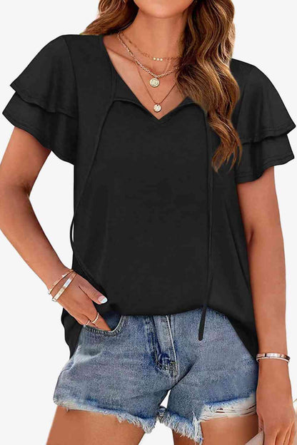 Blusa con mangas acampanadas y capas con cuello anudado