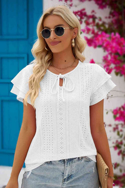 Blouse à manches flottantes et col noué à œillets