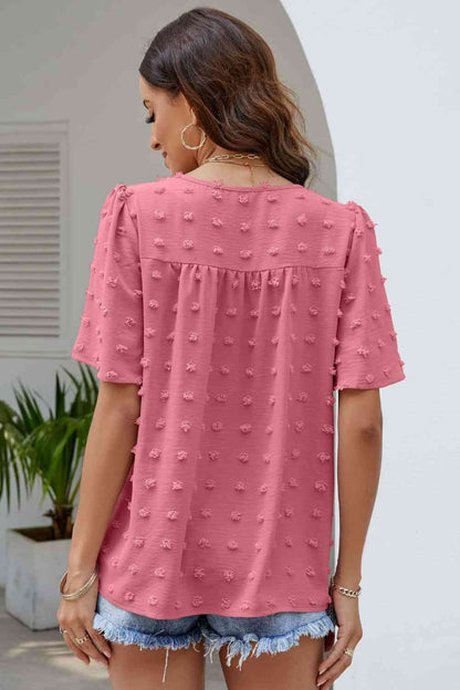 Blusa con cuello redondo y mangas abullonadas con lunares suizos