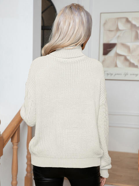 Suéter de manga larga de punto trenzado con cuello alto