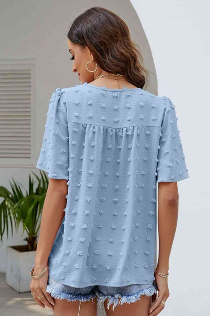 Blusa con cuello redondo y mangas abullonadas con lunares suizos