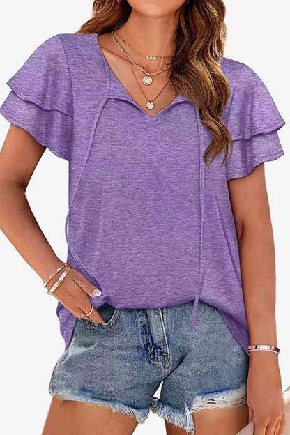 Blusa con mangas acampanadas y capas con cuello anudado