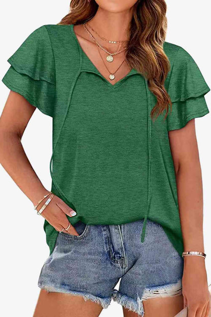 Blusa con mangas acampanadas y capas con cuello anudado