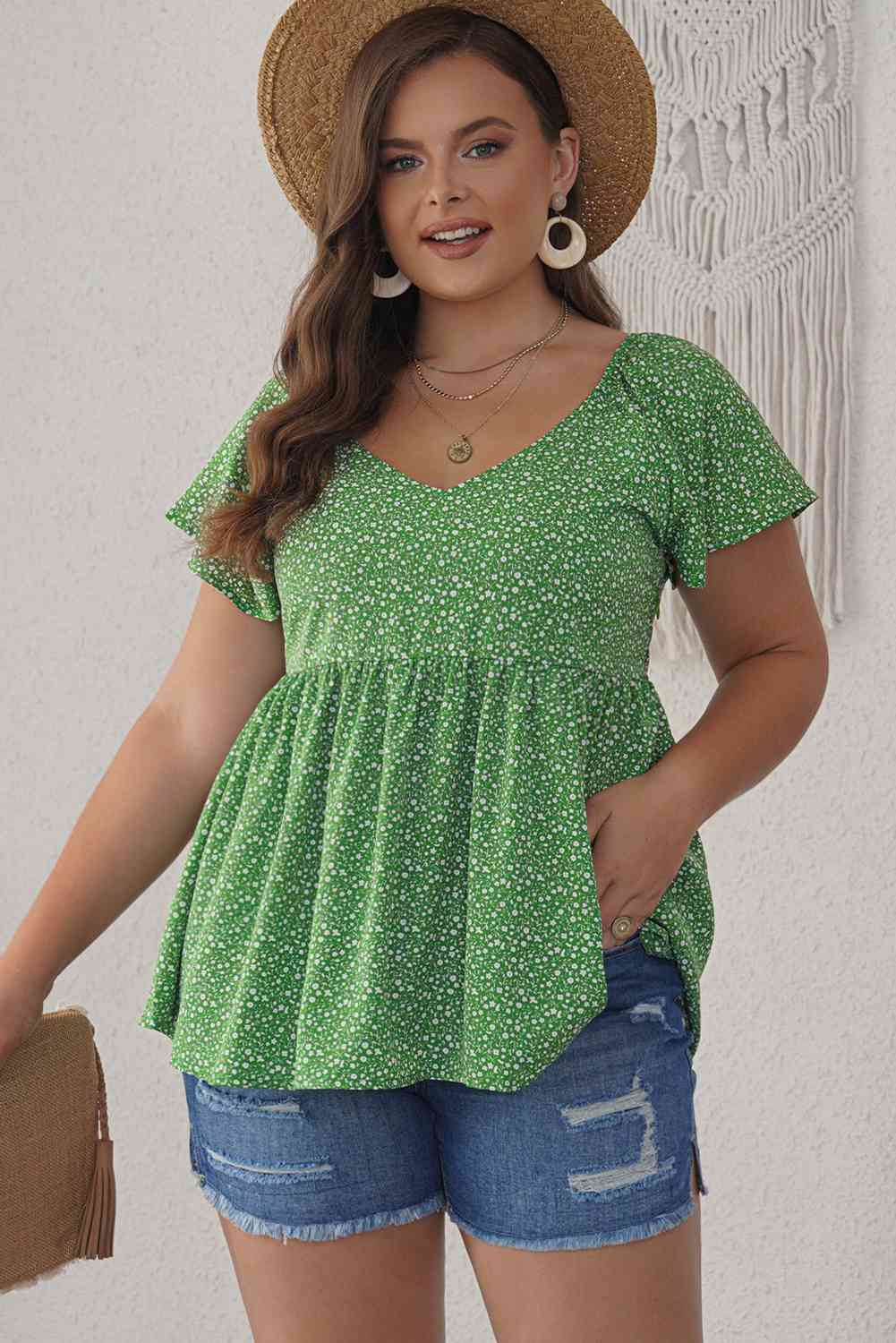 Blusa peplum con mangas acampanadas y estampado floral de florecitas