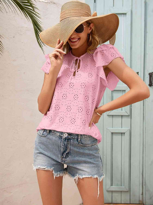 Blouse à manches flottantes et col noué à œillets