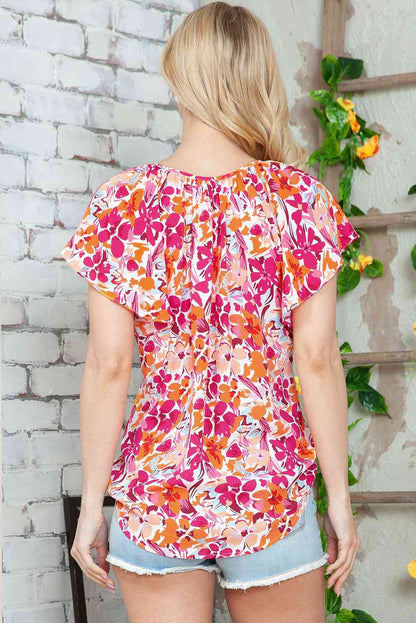 Blusa con mangas abullonadas y cuello con lazo floral