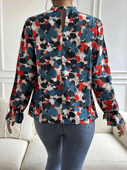 Blouse florale à col montant et manches longues à volants