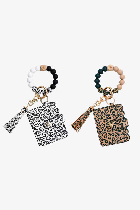 Paquete de 2 llaveros de pulsera con borla y mini monedero de leopardo al azar