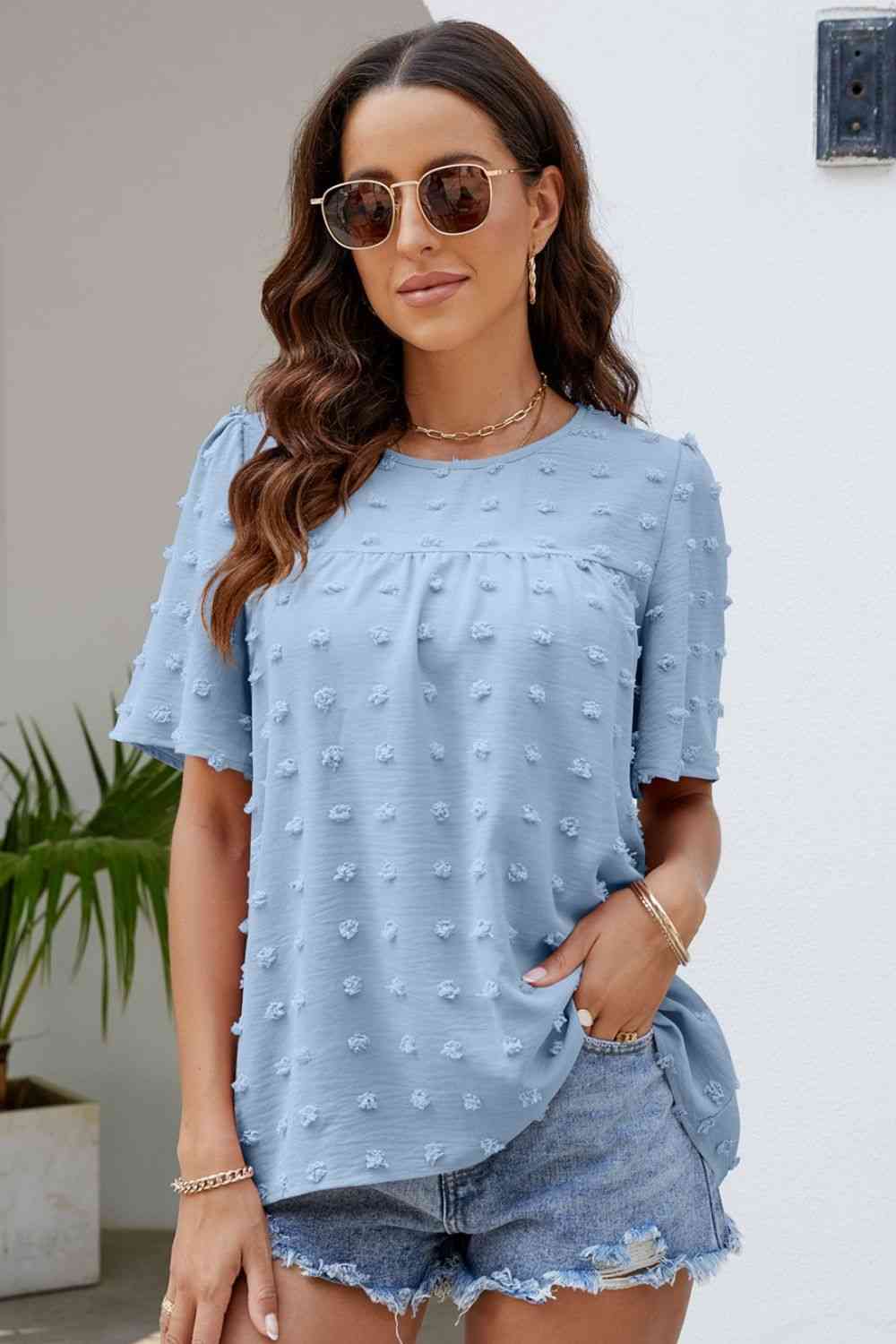 Blusa con cuello redondo y mangas abullonadas con lunares suizos